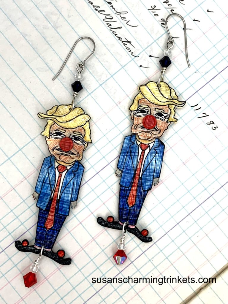 Donald trump wearing a clown nose earrings with red beads