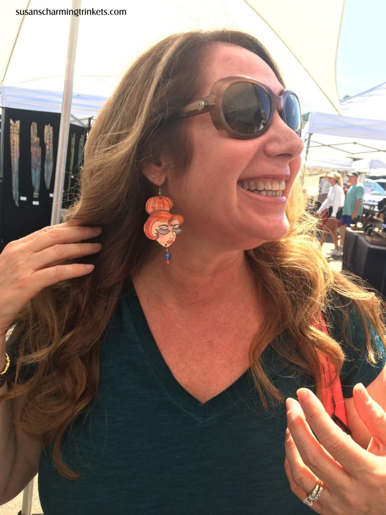 Little ginger lady earrings with long eyelashes and a small blue bead